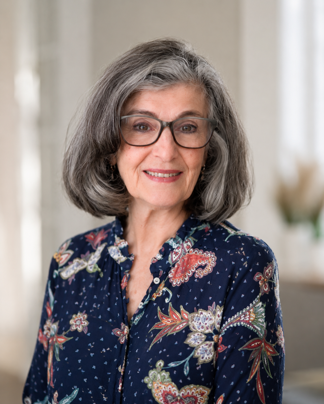 Woman in a navy patterned shirt.